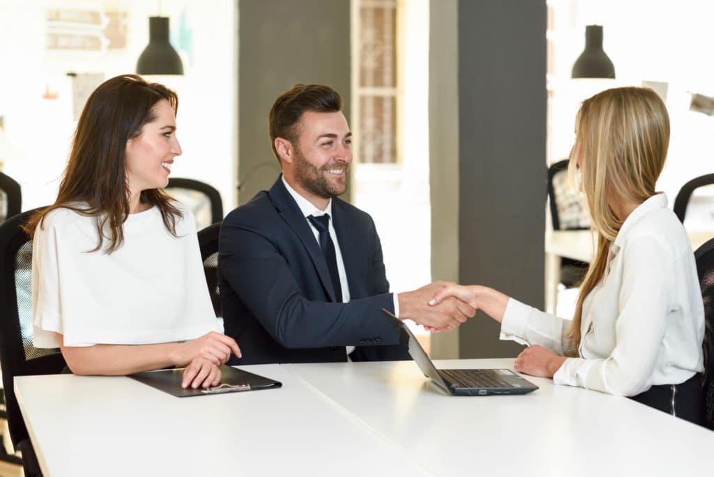 supervisor and trainee appraiser shaking hands